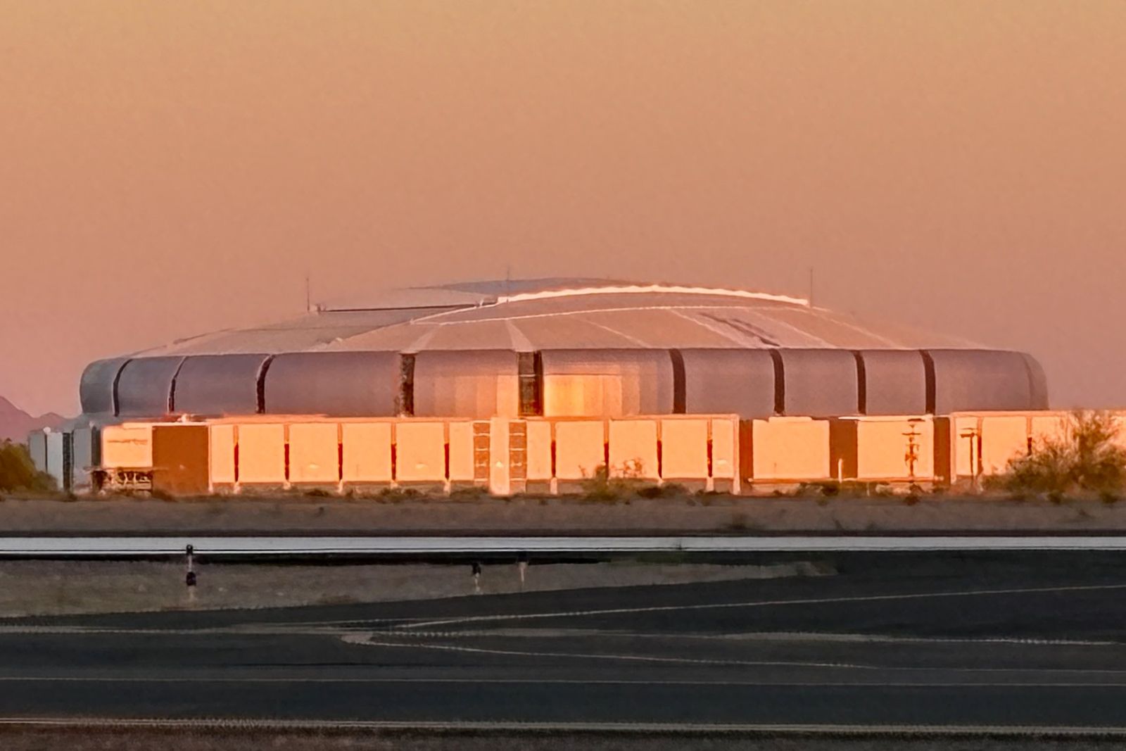 State Farm Stadium at sunset, seen across the taxiway at Glendale Airport